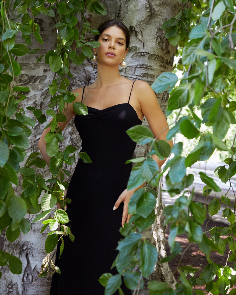 Second image of Evelyn Dress, a black bridesmaid maxi-length dress with ruched bust detail, sweetheart neckline, tiered skirt, back smocking, adjustable straps, back zipper, and lining